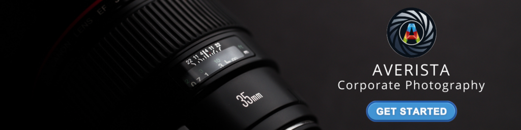 Close-up of a professional camera lens with a call-to-action for corporate headshots.