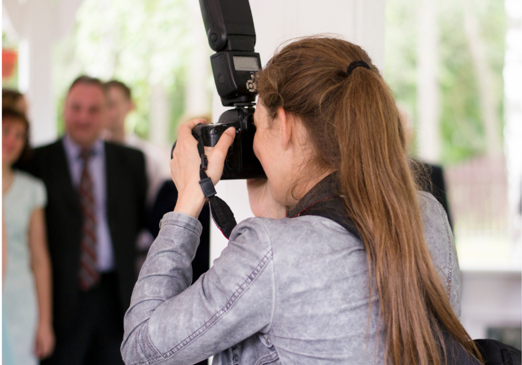 Professional photographer setting up a corporate team headshot session with employees.